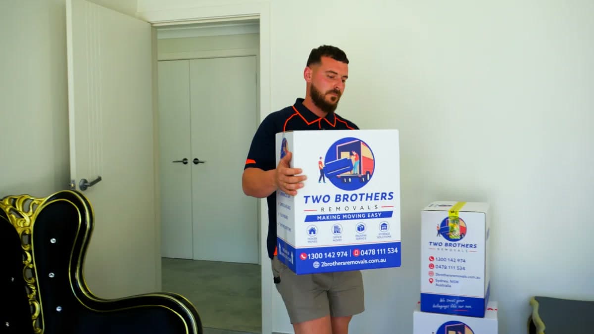 Removalist carrying a shrink-wrapped mattress to the truck