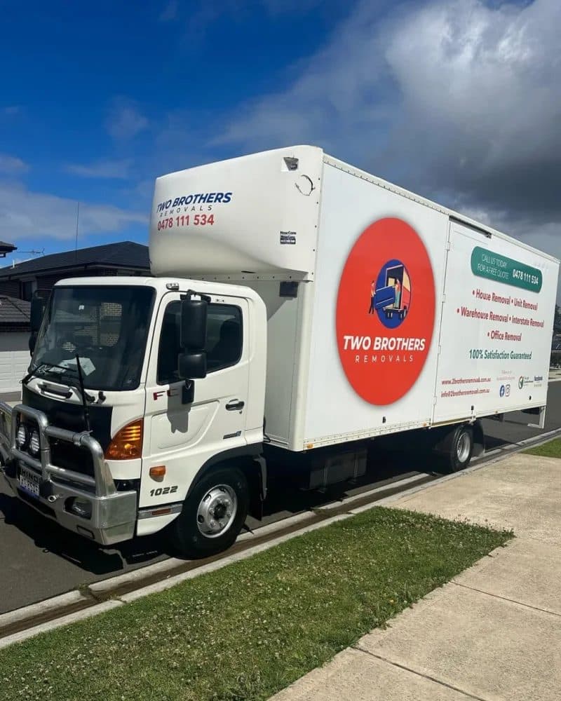 Modern Two Brothers Removals Hino moving truck parked on a Sydney street