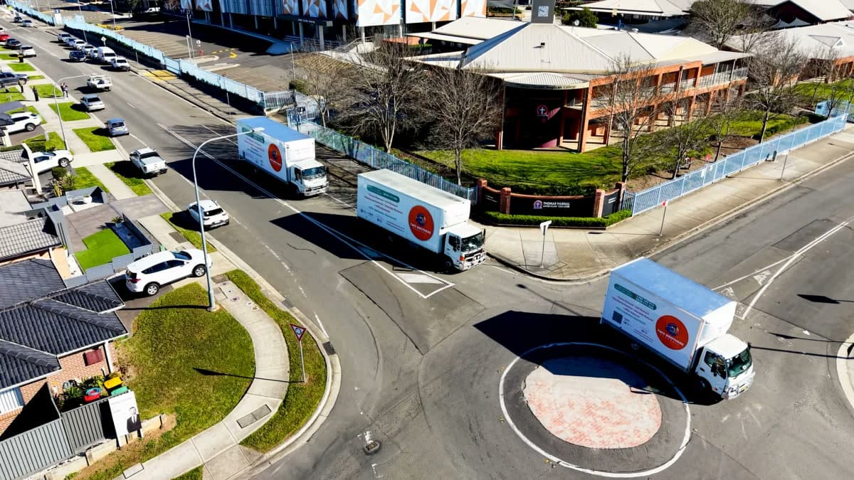 Two Brothers removal trucks parked on a Sydney street curb